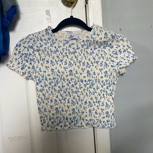 white t shirt with a blue flower pattern
